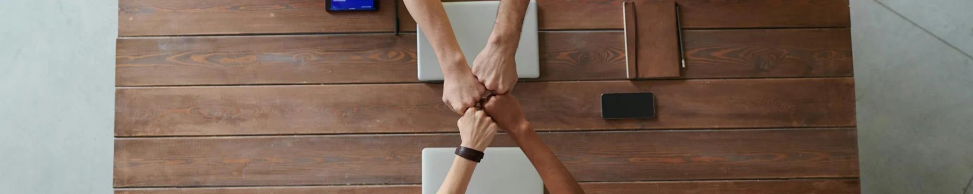 a team of professionals bumping fists in Colorado Springs, CO at IQ Floors | 3350 Fillmore Ridge Heights, Colorado Springs, CO 80907