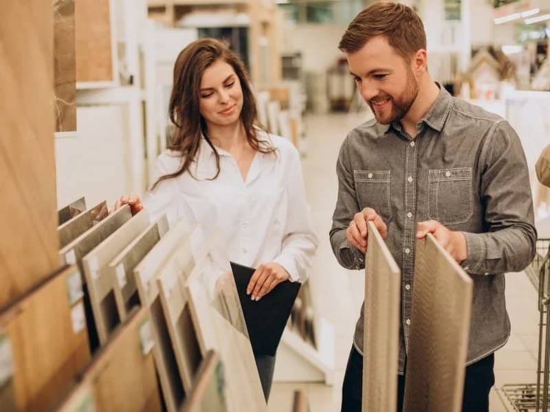 young couple looking at flooring samples in Colorado Springs, CO at IQ Floors