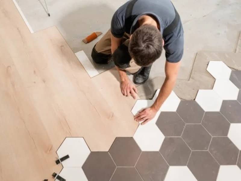 flooring installer combining ceramic and wood flooring in a modern pattern in Colorado Springs, CO at IQ Floors