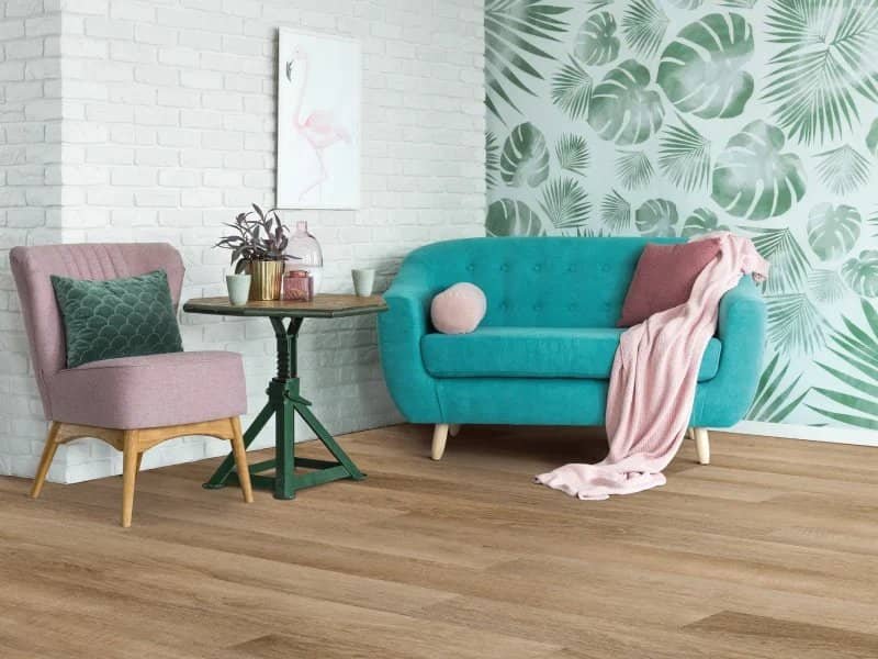 blue couch in living space with leaf wall paper in Colorado Springs, CO at IQ Floors | 3350 Fillmore Ridge Heights, Colorado Springs, CO 80907