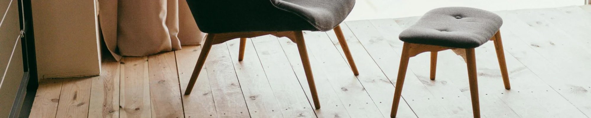 chic chair and ottoman on beautiful wood floor in Colorado Springs, CO at IQ Floors | 3350 Fillmore Ridge Heights, Colorado Springs, CO 80907