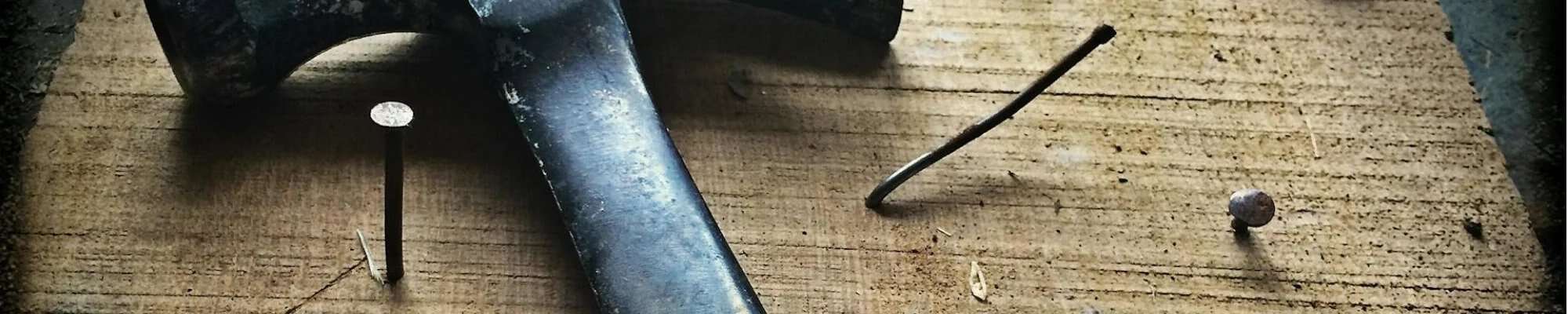 hammer and nails on wooden table in Colorado Springs, CO at IQ Floors